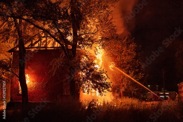 Obraz firefighters put out a burning house