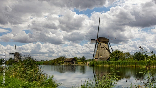 Obraz Windmill along a canal