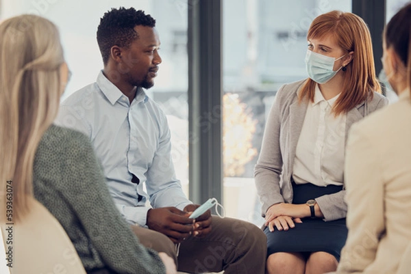 Fototapeta Covid, corporate and employees in a meeting for business, networking and collaboration in office at work. Team of workers, business people and staff talking with face mask at a professional company