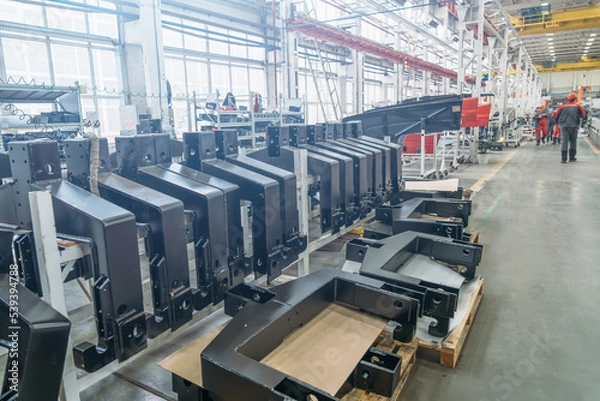 Fototapeta Plant for the production and assembly of agricultural machinery. Assembly line, iron spare parts for machinery.