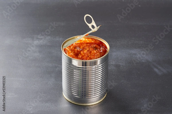 Fototapeta Open iron can on a dark background.