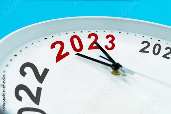 Fototapeta New year number 2022 and 2023 on clock