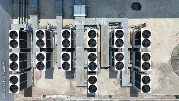 Obraz Bird eye view of many rooftop air compressor unit working slowly and hard on white metal sheet rooftop