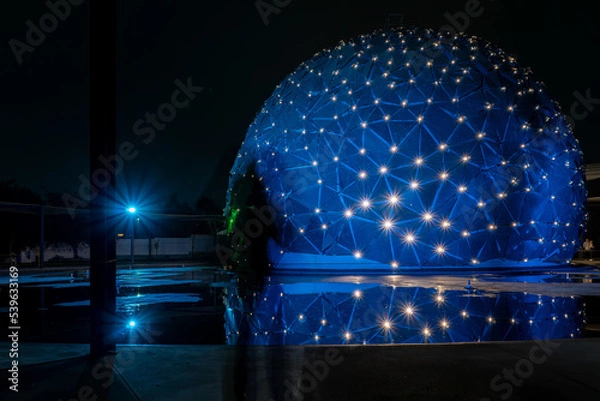 Fototapeta dome shaped building, with colored lights, reflection in water, parametric skin mexico