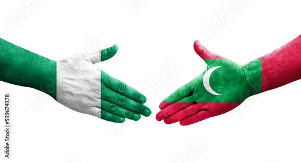 Fototapeta Handshake between Maldives and Nigeria flags painted on hands, isolated transparent image.