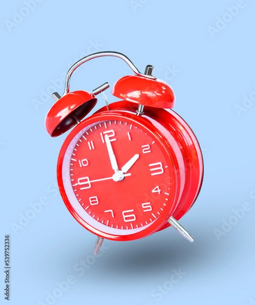 Fototapeta remote image of The red alarm clock is set to 2:00 a.m. a blue background.