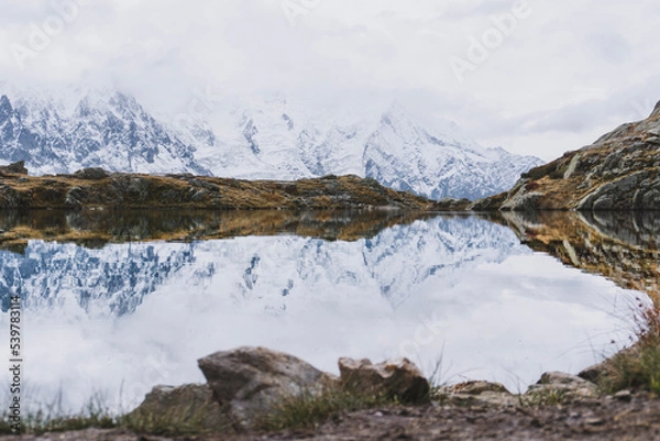 Obraz reflection lake in the mountains covered in snow