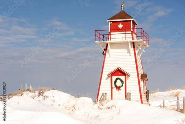 Fototapeta Covehead lighthouse decorated with a Christmas wreath. Located in PEI National Park, Prince Edward Island, Canada.