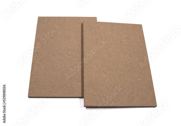 Fototapeta Two boards of raw mdf, leaning against each other, on a white background.