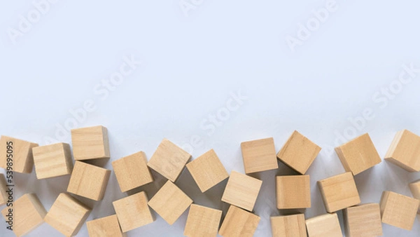 Obraz Top view of wooden cube on a white background with copy space.