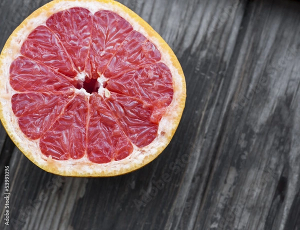 Fototapeta red grapefruit on old table