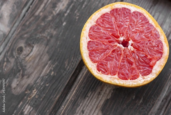 Fototapeta red grapefruit on old table