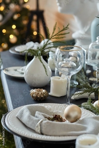 Fototapeta Decoration of a New Year's or Christmas table. Festive tableware and food style. Various decorative elements