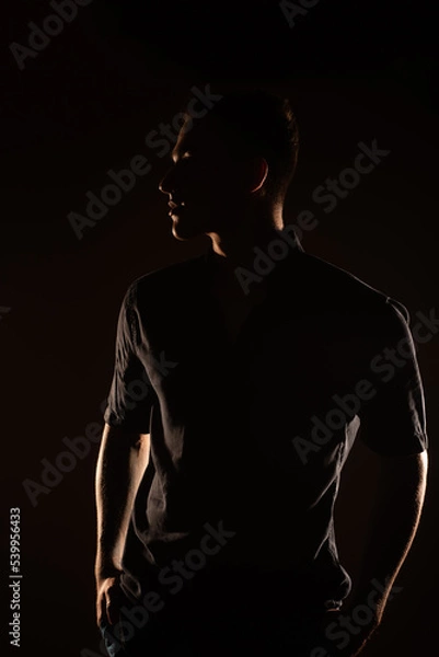 Fototapeta Silhouette of a man in the studio
