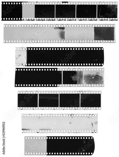 Fototapeta Old, used, dusty and scratched celluloid film strips on transparent background