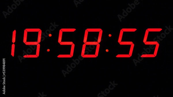 Fototapeta Digital timer on a black background. Light panel with red numbers