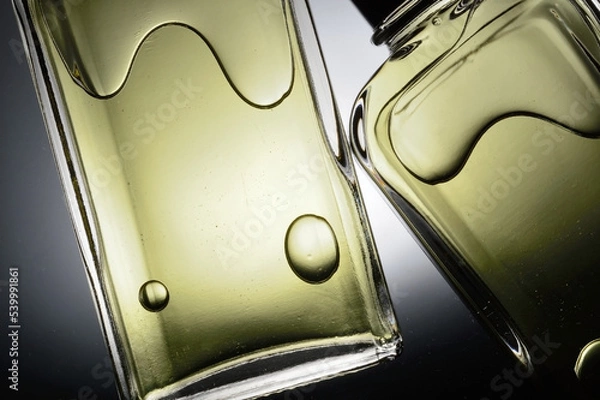 Fototapeta transparent jars with perfume lie on a light background. Close-up