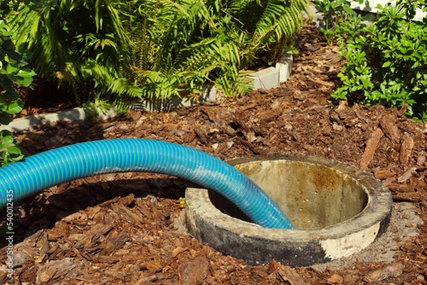 Fototapeta Pipe in the drainage pit. Pumping out sewage from a septic tank.