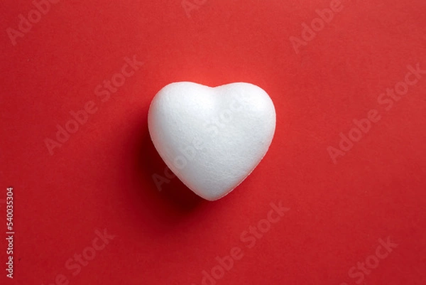 Fototapeta Love shape make from Styrofoam board isolated on red background