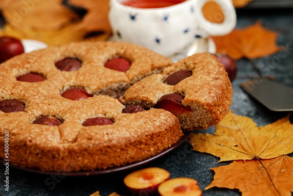 Fototapeta Plum pie. Delicious pie on a concrete table. Autumn design