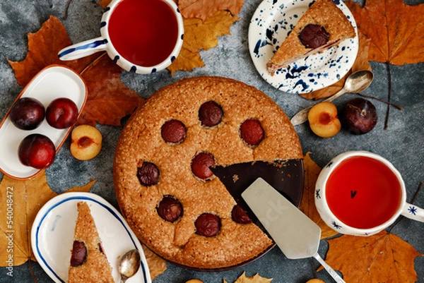 Fototapeta Plum pie. Delicious pie on a concrete table. Autumn design