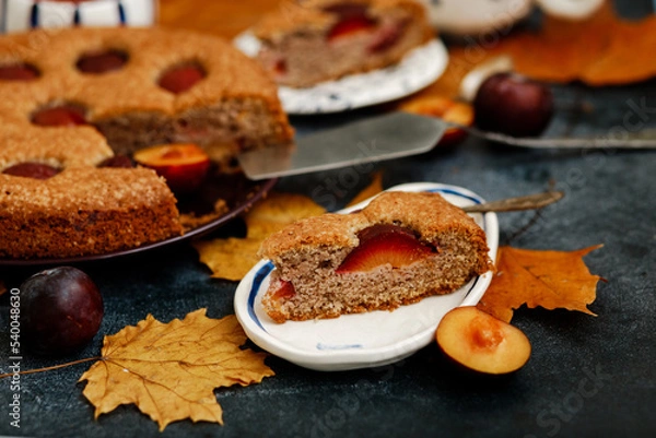 Fototapeta Plum pie. Delicious pie on a concrete table. Autumn design