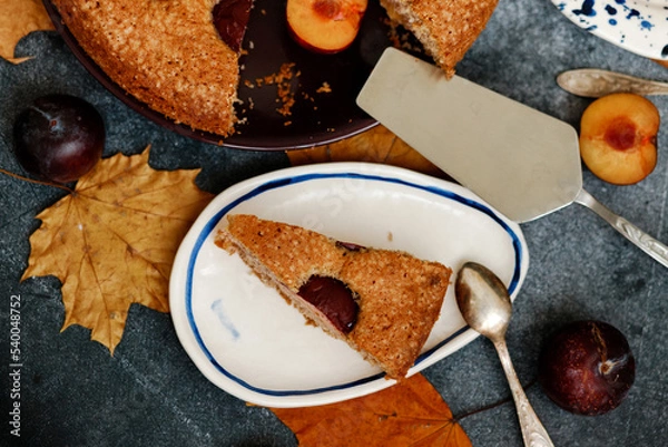 Fototapeta Plum pie. Delicious pie on a concrete table. Autumn design