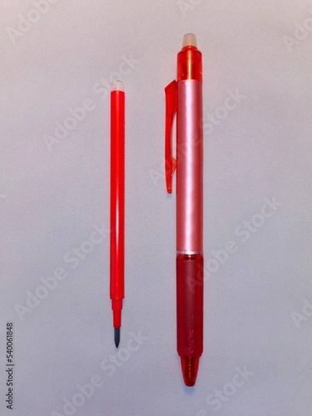Fototapeta A pencil, a red pen, a spare refill placed next to it