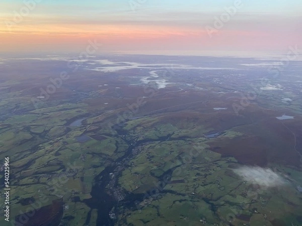Fototapeta View flying over Peak District at sunrise on a foggy morning
