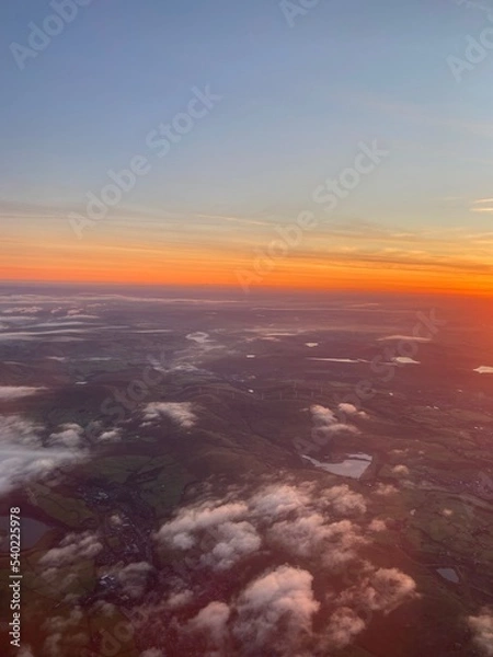 Fototapeta View flying over Peak District at sunrise on a foggy morning