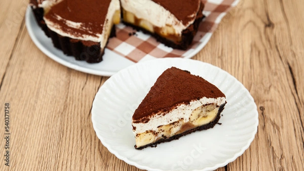 Fototapeta Banoffee pie, banana and caramel with biscuit and fresh cream