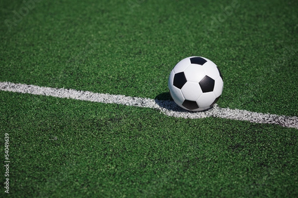 Fototapeta White stripe on the green soccer field from top view