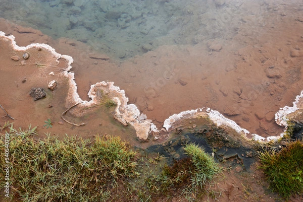 Fototapeta The shore of a hot reservoir formed by geysers in Iceland in the valley of the geyser Strokkur