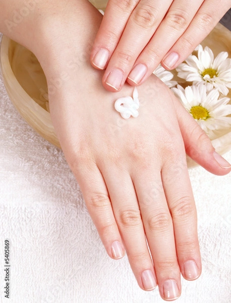 Obraz female applying cream to her hands