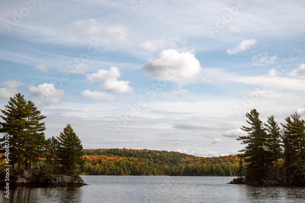 Fototapeta A passage between two points leads to autumn scenery on a fresh water lake. Provoking Lake, Algonquin Provincial Park, Ontario, Canada.