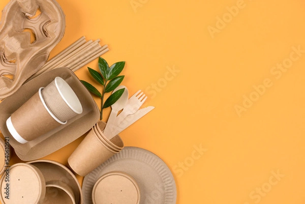 Obraz Eco-friendly tableware set over orange background with copy space - sustainable paper food packaging. Street food paper packaging, recyclable utensils, zero waste packaging concept