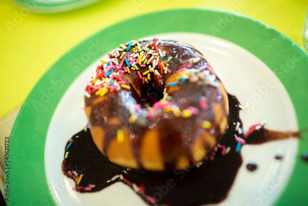 Obraz donut with colourful chocolate sprinkles on the plate
