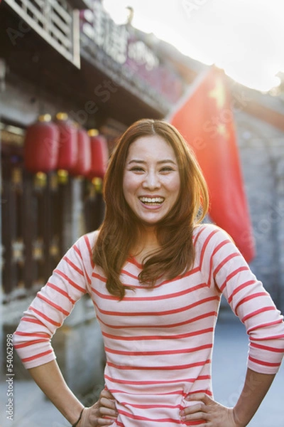 Fototapeta Portrait Of Smiling Young Woman In Houhai, Beijing