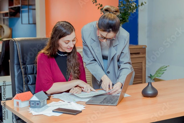 Fototapeta Finance,accounting,Businesswomen analyzing investment charts with calculator laptop calculate technology in office, marketing business analysis data concept