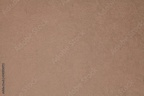 Fototapeta Brown, terracotta texture and background. Decorated surface with round ornamental embossed pattern. Pale light-brown wall surface with abstract pattern.  Embossed ornament of building wall plastering