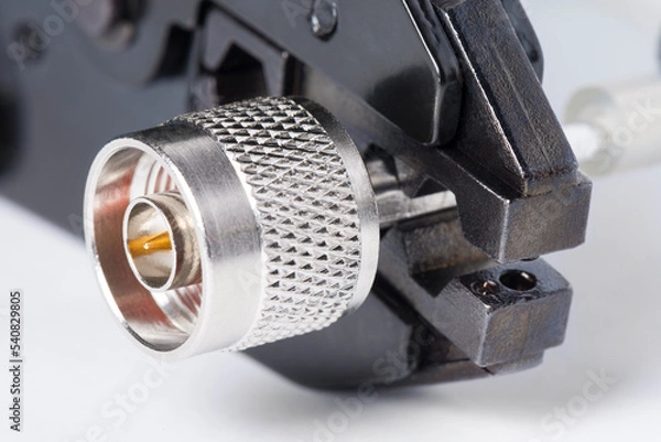 Fototapeta Crimping tool with N male type coaxial connector and cable.  High frequency connector used in radio wave systems, high frequency transmitters and communication systems.