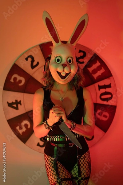 Obraz Girl dressed as a scary rabbit with a knife. halloween concept