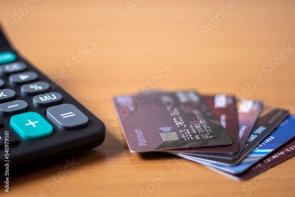 Obraz Three credit cards put a spoon on the table.