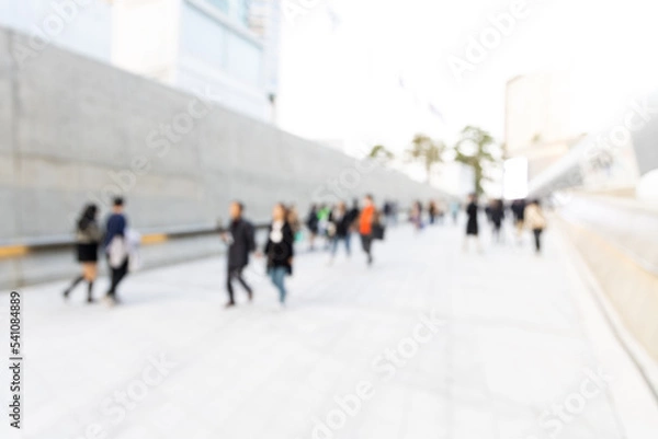 Fototapeta Blurred view of Seoul street with modern buildings, pavements and stylish people walking. Can be used as background. De focused image of capital of south Korea.