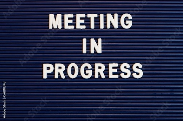 Fototapeta Pushboard sign that says meeting in progress in plastic letters