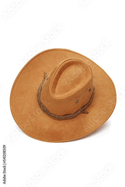 Fototapeta Close-up shot of a light brown wide-brimmed cowboy hat with a chin strap. The men's cowboy hat is isolated on a white background. Diagonal top view.
