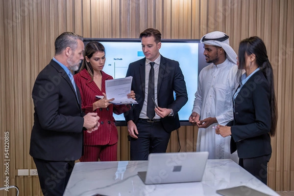 Obraz Group of business diversity people and middle east in office in the meeting room stand near big screen TV presentation contract agreement and signature close deal clap hands