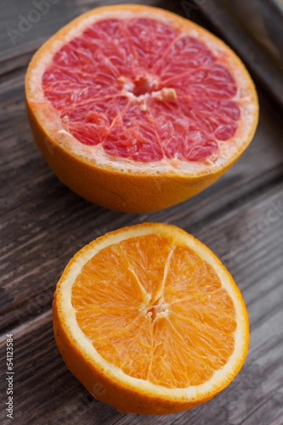 Fototapeta red grapefruit and orange on old table