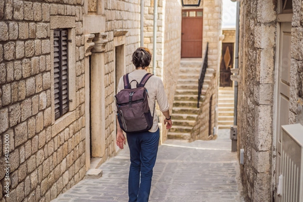 Fototapeta The man in Ulcinj town in Montenegro. Clock Tower of Ulcinj Sahat Kulla. Lami Mosque. Ulcinj is a popular tourist destination in the summer on the southern Adriatic coast of Montenegro. Ulqin