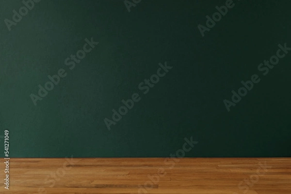 Fototapeta Dark bottle green background for copy space and wooden table